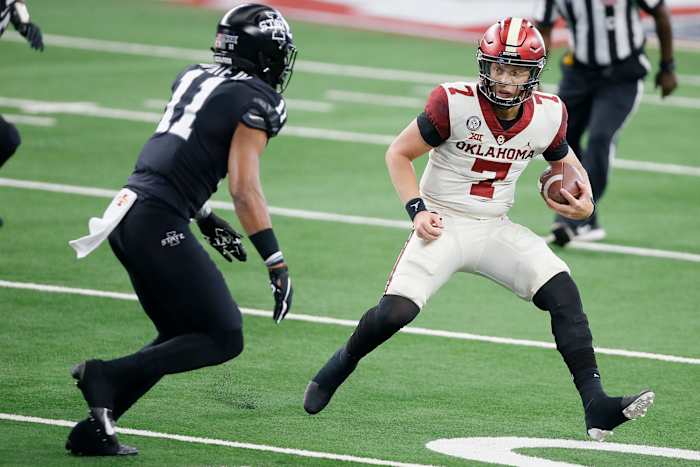 Oklahoma's Spencer Rattler (7) tries to runs past Iowa State's Lawrence White IV (11) during the Big 12 Championship Game between the University of Oklahoma Sooners (OU) and the Iowa State Cyclones at AT&T Stadium in Arlington, Texas, Saturday, Dec. 19, 2020. Oklahoma won 27-21. [Bryan Terry/The Oklahoman